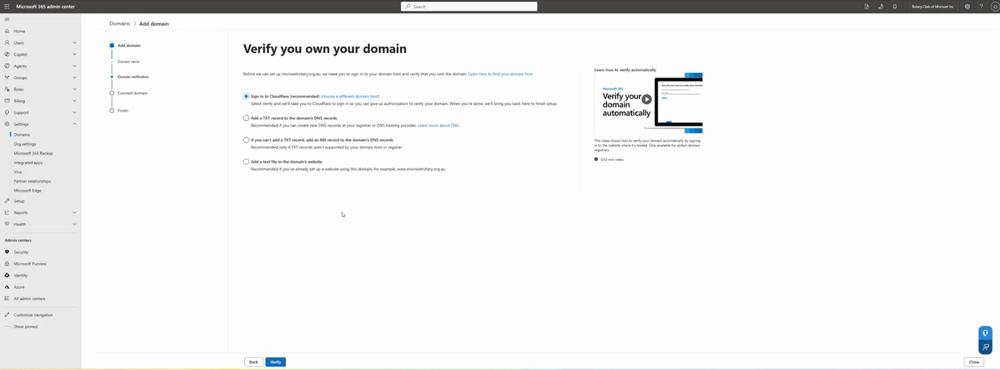 The Verify you own your domain step of the Add domain wizard, offering to sign in to the DNS host, add a TXT record, add an MX record, or add a text file to the domain's website